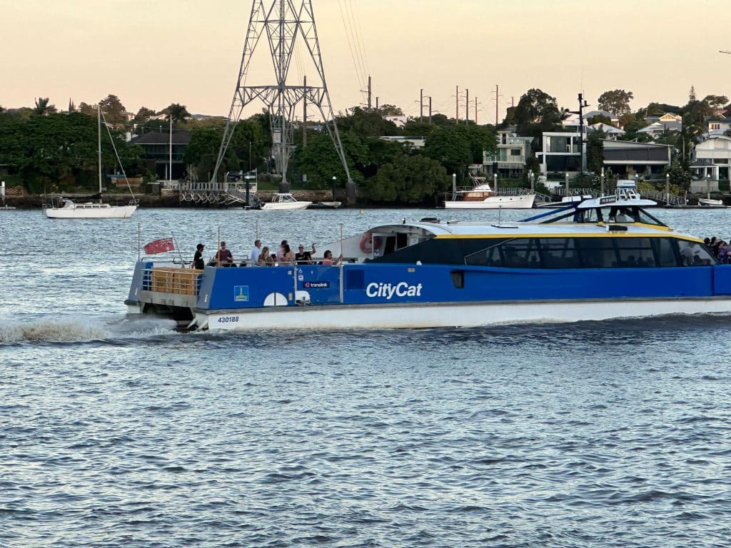 CityCat water ferry passing Wharf Park toward Teneriffe ferry terminal