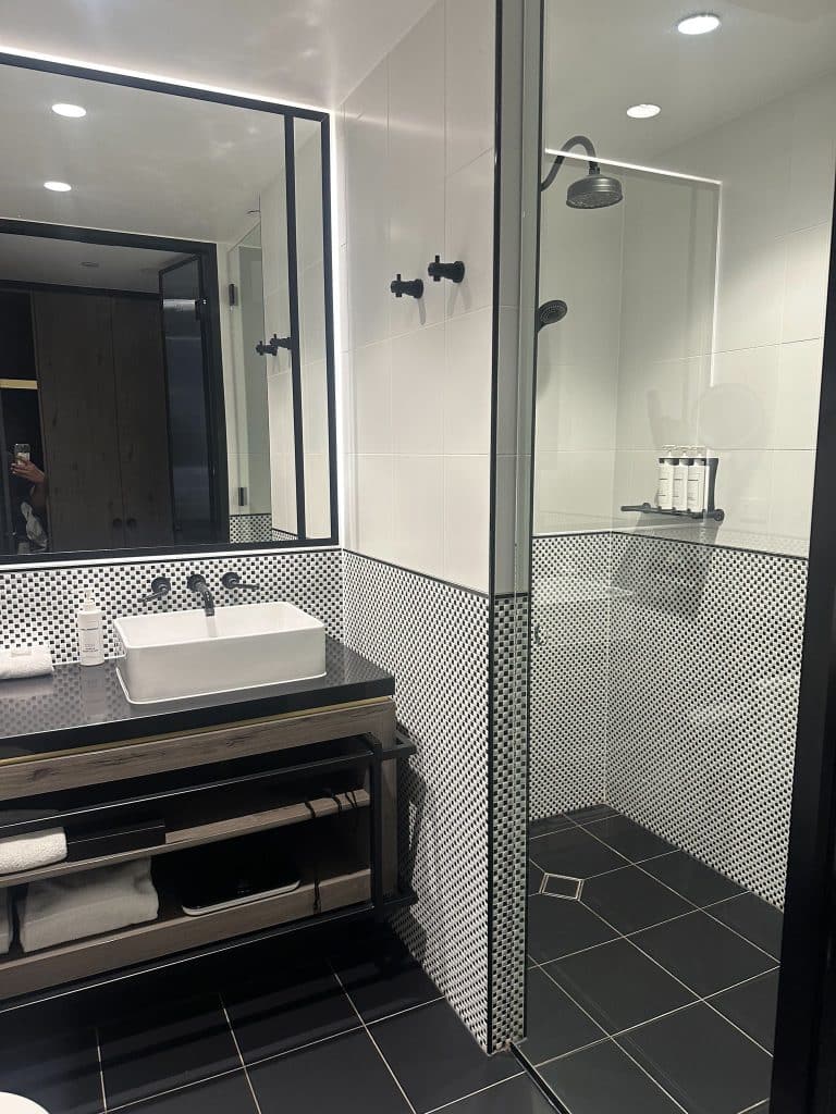 Hotel X Brisbane black-and-white tiled bathroom with walk-in shower and designer amenities