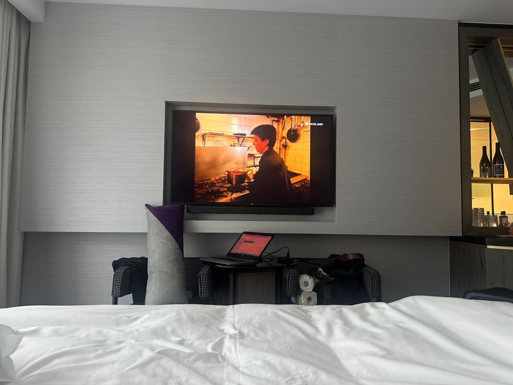Hotel X Brisbane bedroom TV with remote work setup