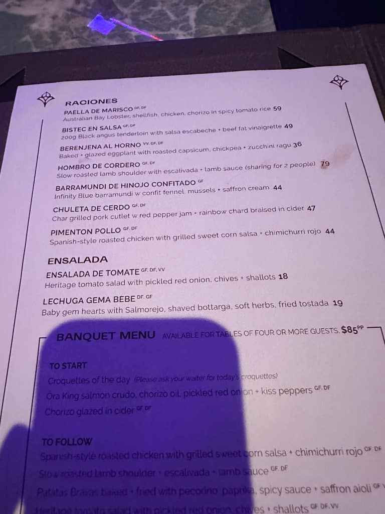 Iris Rooftop Bar dinner menu featuring Angus beef, lamb shoulder, and paella
