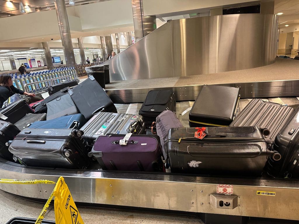 Baggage carousel at LAX full of luggage for passengers arriving on international flights.