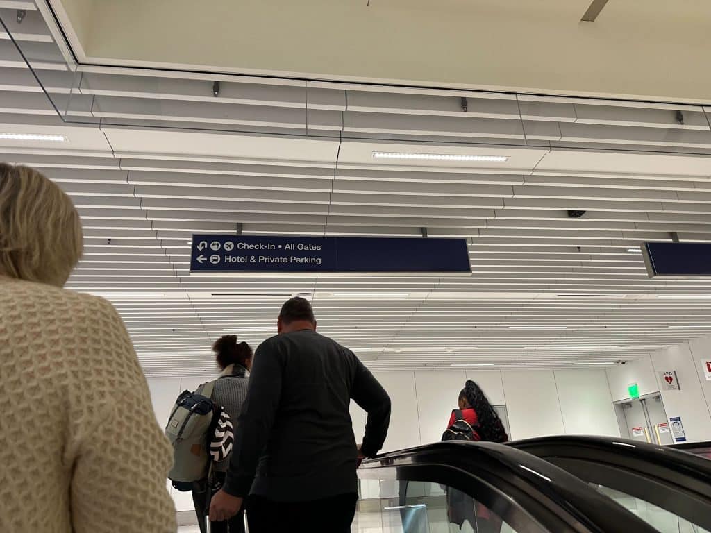 Passengers going up escalators in LAX Terminal 3 after international baggage claim.