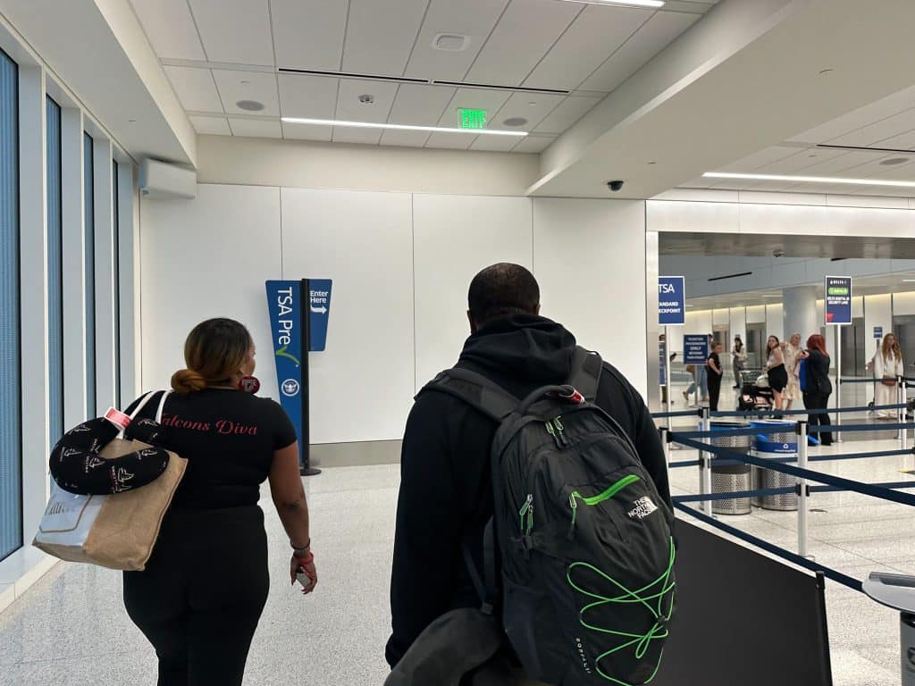 TSA PreCheck entrance at LAX Terminal 3 with travelers entering security screening area.