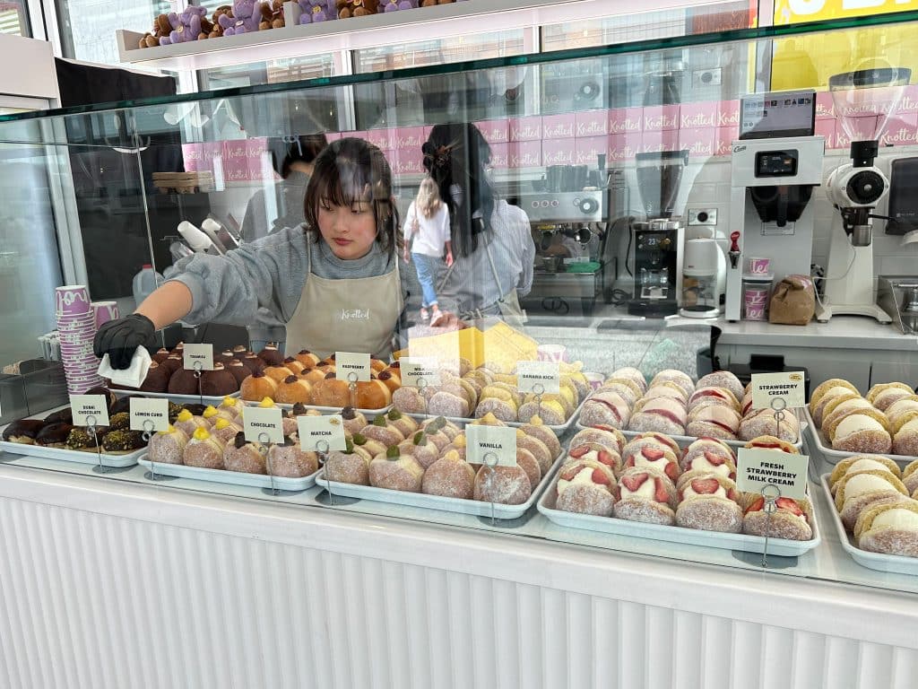Assortment of Korean-style donuts including matcha, vanilla, and fresh strawberry at Cafe Knotted in Westfield Century City mall, Los Angeles.